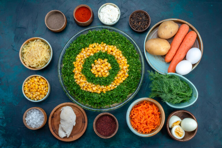 top view greens salad with corns along with with seasonings eggs dark blue background